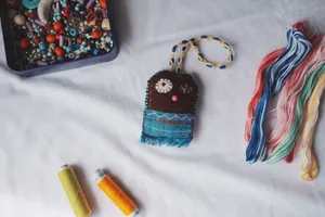 Colorful collection of beads, threads, and a handcrafted item showcasing vibrant craft materials. jigsaw puzzle
