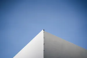A minimalist architectural corner against a vivid blue sky showcasing simplicity and modern design. jigsaw puzzle