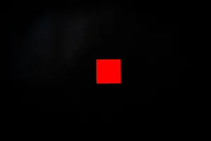 Vivid red square centered on a minimalist black background, creating a striking visual contrast. jigsaw puzzle