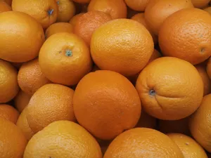 A vibrant collection of fresh oranges stacked closely together, showcasing their bright color. jigsaw puzzle
