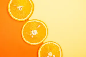 Juicy orange slices on a vivid yellow and orange gradient background. jigsaw puzzle
