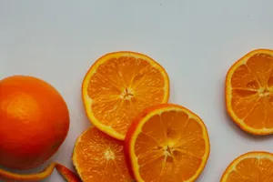 Colorful slices of fresh orange fruit displayed on a clean white background. jigsaw puzzle