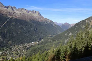 A scenic mountain valley with a small town nestled within. jigsaw puzzle