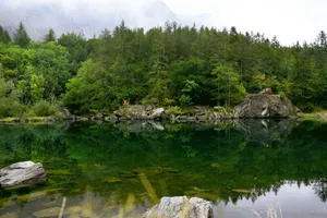 a body of water surrounded by trees and rocks jigsaw puzzle