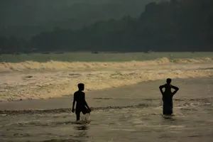 a couple of people that are standing in the water jigsaw puzzle