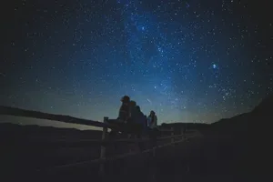 several women sitting on fence watching milky way jigsaw puzzle