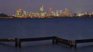 City skyline illuminated at dusk over calm water jigsaw puzzle