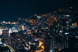 A vibrant cityscape at night with illuminated buildings and streets. jigsaw puzzle