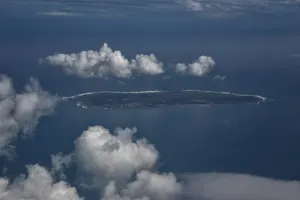 an island in the middle of the ocean surrounded by clouds jigsaw puzzle