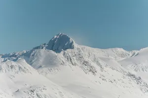 a mountain covered in snow under a blue sky jigsaw puzzle