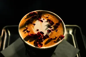 a cup of coffee with rose petals on top jigsaw puzzle