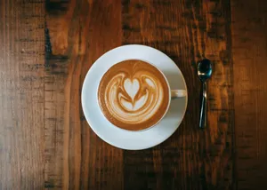 white ceramic cup with saucer on brown wooden table jigsaw puzzle