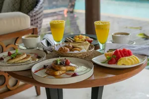 A wooden table topped with plates of food jigsaw puzzle