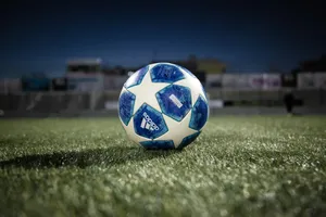 white blue soccer ball on green grass field during daytime jigsaw puzzle