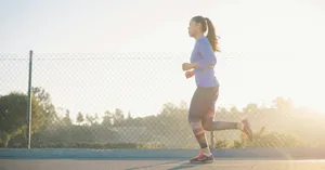 woman jogging near wire fence jigsaw puzzle
