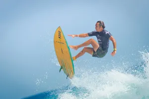 man in black wetsuit surfing on sea waves during daytime jigsaw puzzle
