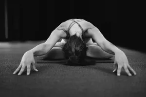 woman in white tank top bending her body on floor jigsaw puzzle