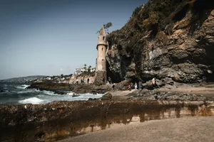 brown concrete building on brown sand near body of water during daytime jigsaw puzzle