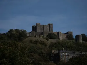 A castle sitting on top of a lush green hillside jigsaw puzzle