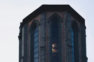 a tall brick building with a clock on it's side jigsaw puzzle