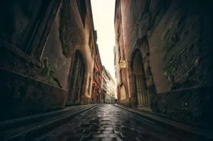 Narrow cobblestone street between old buildings jigsaw puzzle