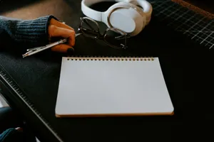 a notepad, pen and headphones on a table jigsaw puzzle