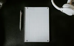 a notepad with a pen on top of it next to a mug jigsaw puzzle