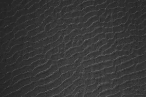 a black and white photo of a textured surface jigsaw puzzle