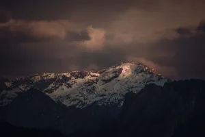 Majestic snow-capped mountains under dramatic evening sky. jigsaw puzzle