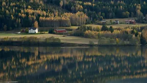 Serene rural landscape with autumnal trees reflecting in a calm lake. jigsaw puzzle