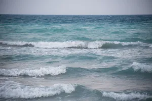 Peaceful view of ocean waves gently crashing on a calm sea day. jigsaw puzzle
