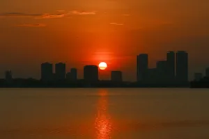Stunning sunset over Hanoi skyline with a vivid orange sky reflecting on the water. jigsaw puzzle