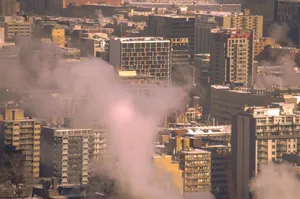 City skyline with smoke rising from buildings, showcasing urban winter scene in Montreal. jigsaw puzzle