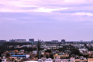 Aerial view of a city skyline under a cloudy sky with scattered high-rise buildings. jigsaw puzzle