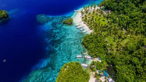 Stunning aerial vista of a turquoise beach in Caraga, Philippines, surrounded by lush greenery. jigsaw puzzle