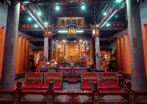 Richly decorated Asian temple interior showcasing a sacred altar and traditional religious elements. jigsaw puzzle