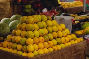 Stack of ripe oranges on display at a bustling local market, perfect for a vibrant visual element. jigsaw puzzle