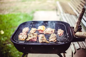 Juicy beef and chicken sizzling on a charcoal grill during a sunny outdoor cookout. jigsaw puzzle