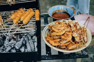 Delicious grilled shrimp, squid, and skewers over a charcoal grill with spicy dipping sauce. jigsaw puzzle