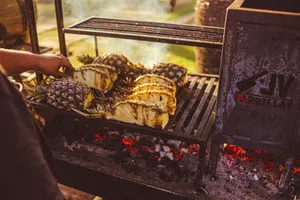 Close-up of pineapples being grilled on a charcoal grill, showcasing tropical flavors. jigsaw puzzle