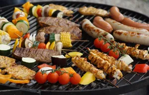 A vibrant assortment of grilled meats, sausages, and vegetables on a barbecue grill. jigsaw puzzle