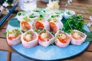 Vibrant sushi rolls on a plate with fresh greens, perfect for a gourmet meal. jigsaw puzzle