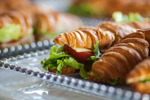 Fresh croissant sandwiches with cheese, tomato, and lettuce, perfect for a tasty meal. jigsaw puzzle