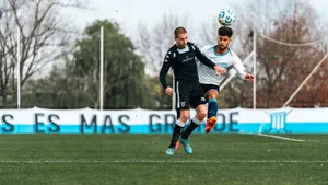 Two soccer players in action during an intense match, competing for the ball outdoors. jigsaw puzzle