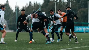 Intense soccer practice with team players competing for the ball on a green field. jigsaw puzzle