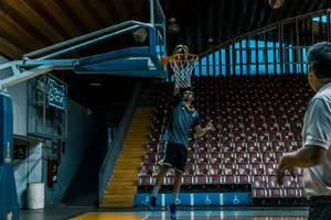 Athletes practicing basketball shoots during an indoor training session. jigsaw puzzle
