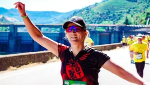 A joyful female runner celebrates during an outdoor marathon on a sunny day. jigsaw puzzle