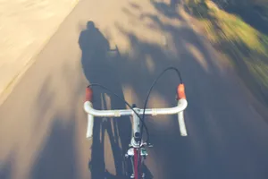 Blurred motion shot of a racing bike with a shadow on a sunny day. jigsaw puzzle