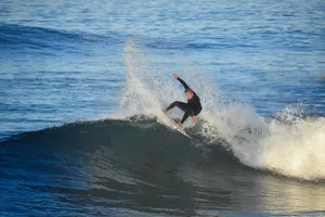 Surfer expertly rides and performs tricks on a powerful ocean wave. jigsaw puzzle