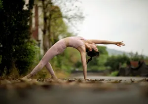 Woman practicing yoga outdoors on a forest road, emphasizing fitness and balance. jigsaw puzzle